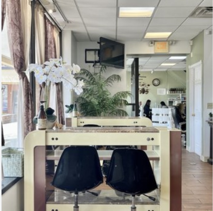 Inside Posh Nail Lounge, with orchids and manicure stations